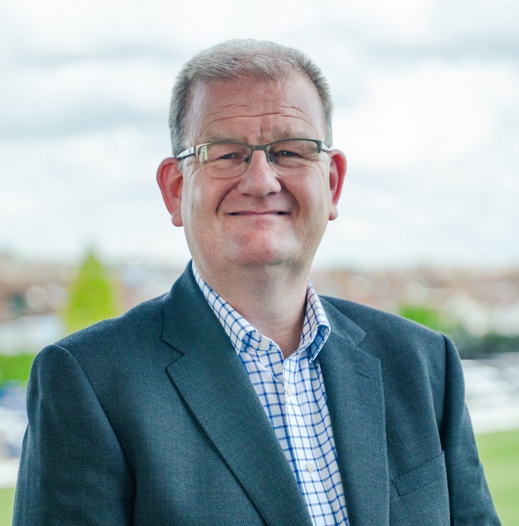 A photo of ICB chief executive, Shane Devlin. He is facing the camera and smiling.