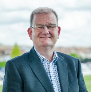 A photo of ICB chief executive, Shane Devlin. He is facing the camera and smiling.