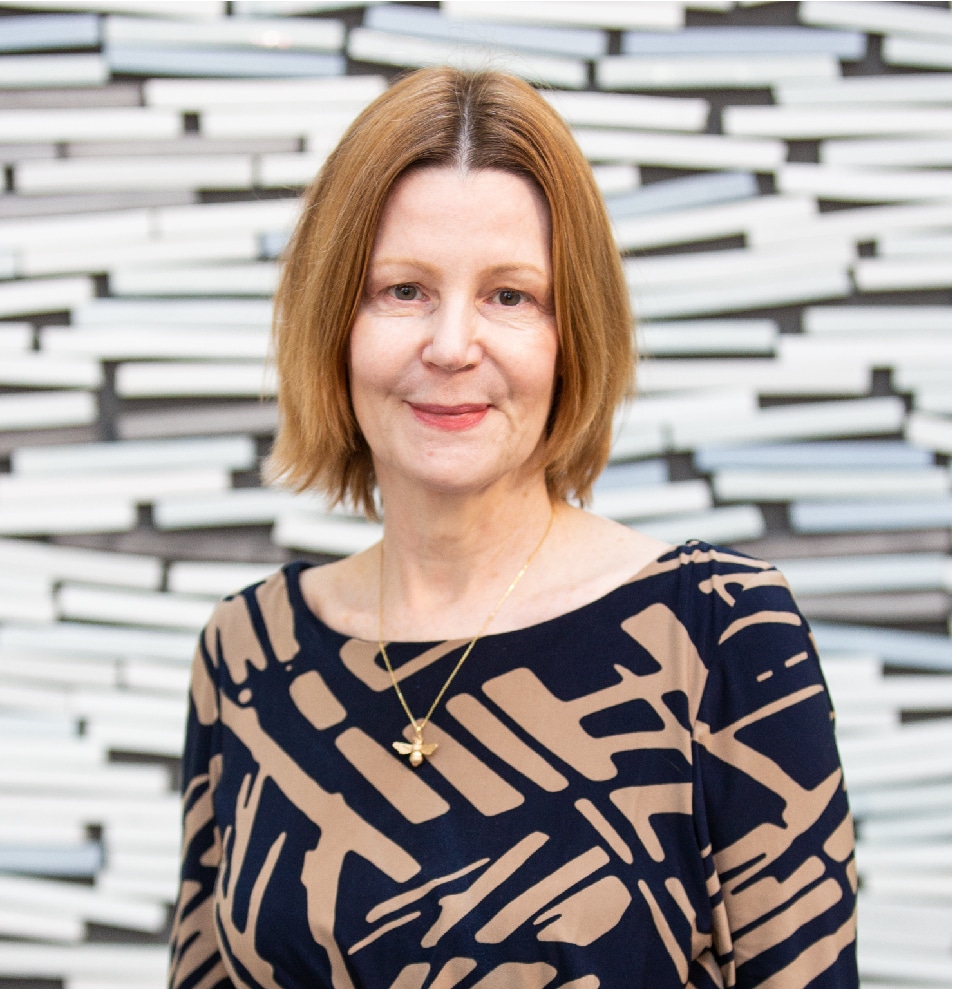 Maria Kane - head shot smiling - wall background