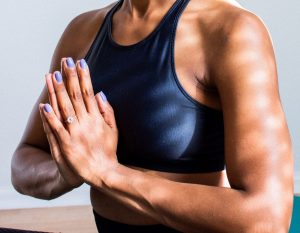 Woman holding her hands in the prayer pose