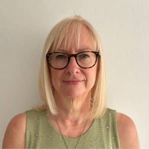 A photo of Jo Beer. She is facing the camera and smiling.